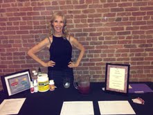 A woman standing in front of a table with some drinks